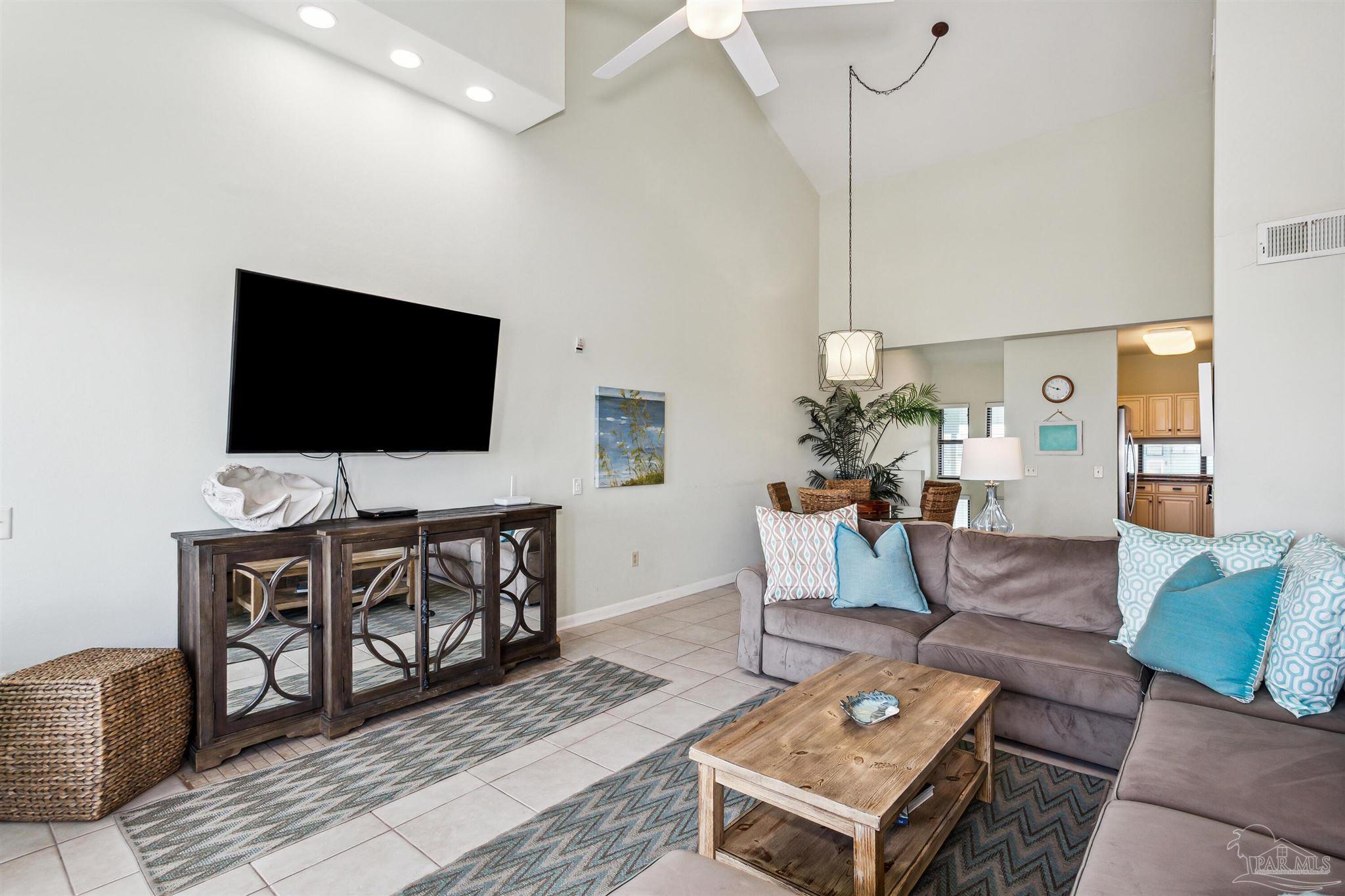 1390 Fort Pickens Road, Unit 229 Pensacola Beach, FL 32561 - Photo 9 of 47 a living room with furniture and a flat screen tv