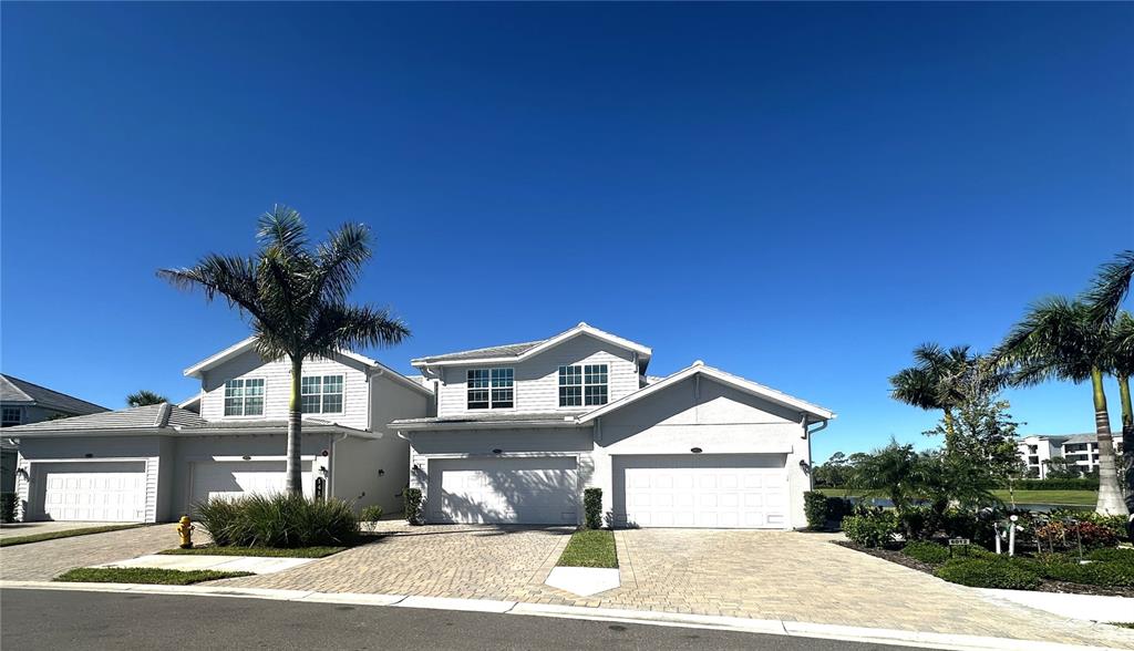 14149 Poppy Field Loop, Unit 6012 Punta Gorda, FL 33950 - Photo 1 of 49 a front view of a house with a yard and garage