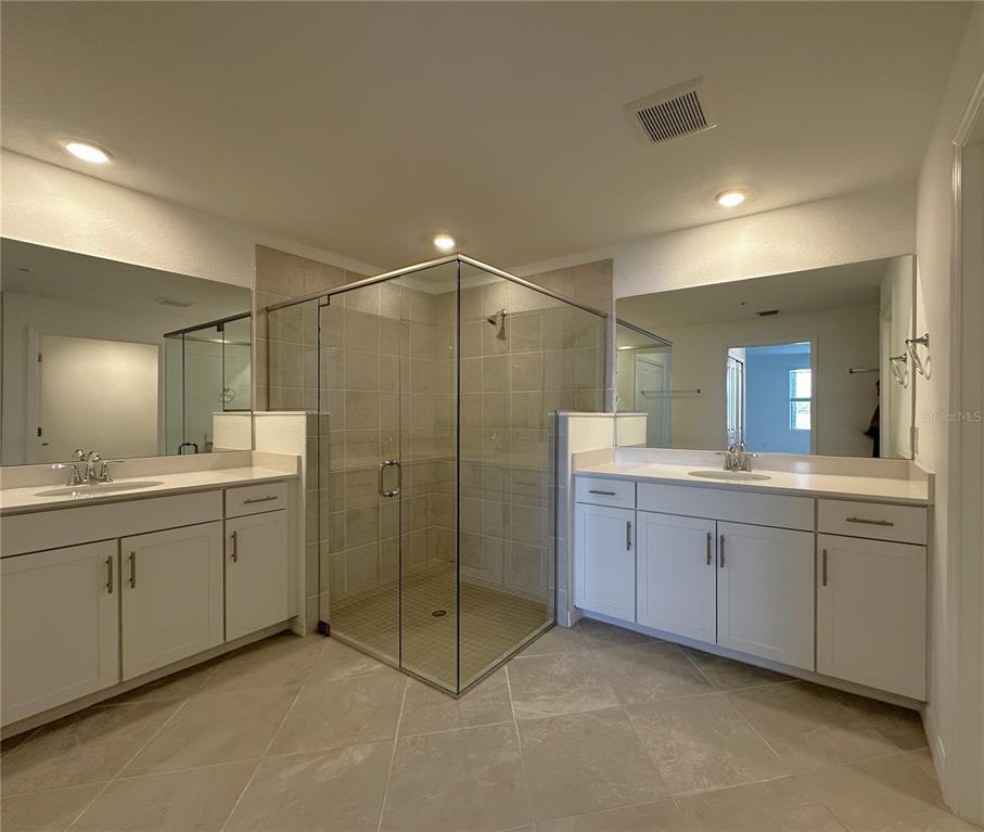 14149 Poppy Field Loop, Unit 6012 Punta Gorda, FL 33950 - Photo 11 of 49 a bathroom with double sink and a mirror