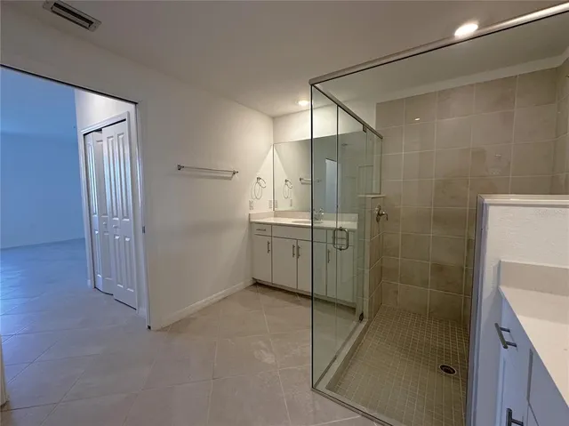 a bathroom with a shower and a sink