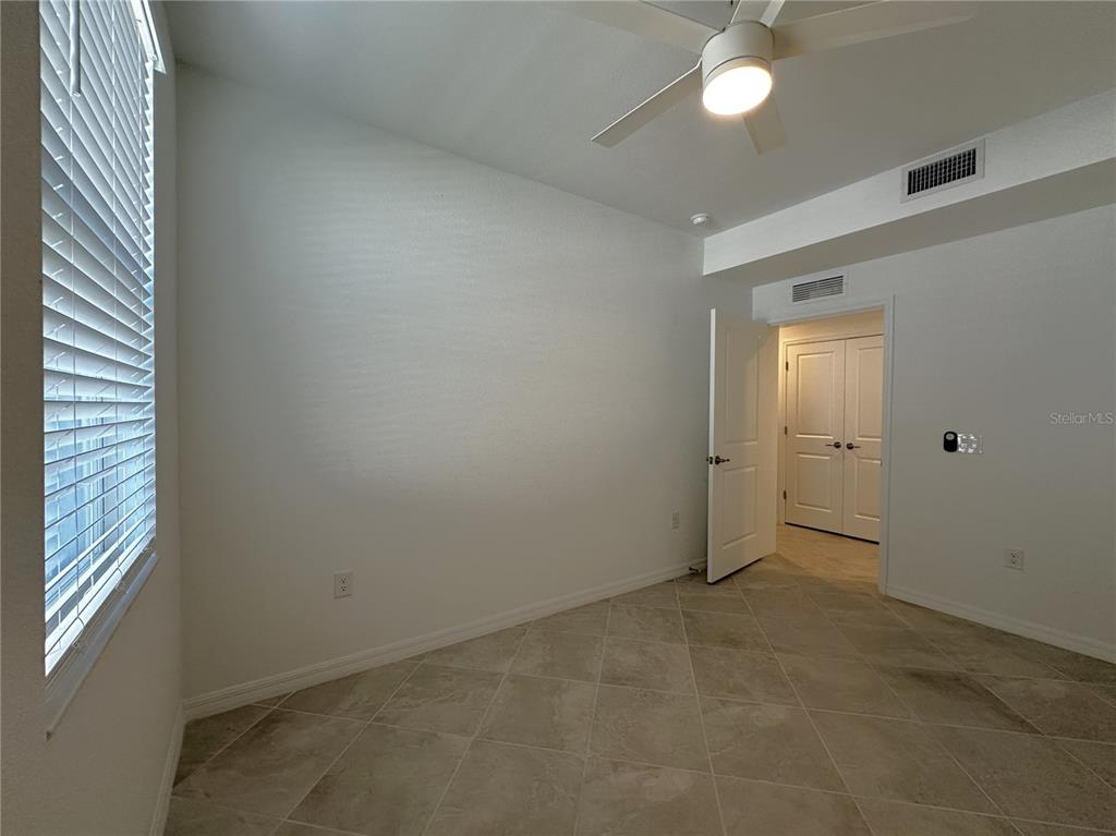 14149 Poppy Field Loop, Unit 6012 Punta Gorda, FL 33950 - Photo 18 of 49 an empty room with windows and fan