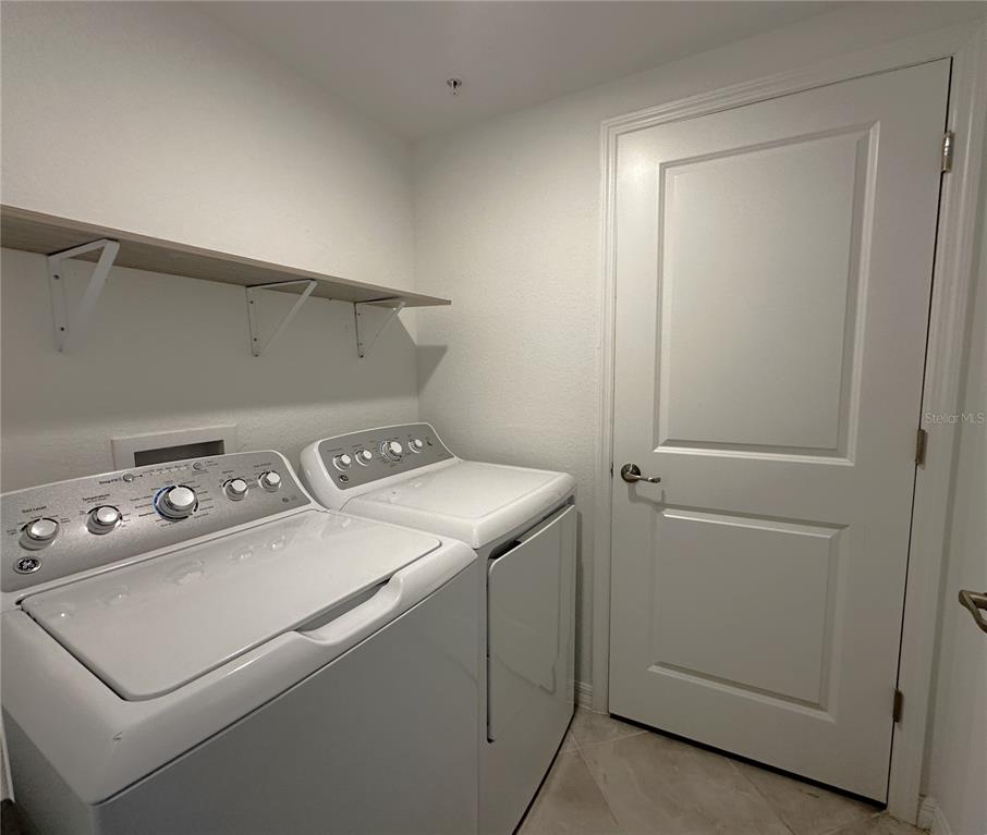 14149 Poppy Field Loop, Unit 6012 Punta Gorda, FL 33950 - Photo 19 of 49 a utility room with dryer and washer
