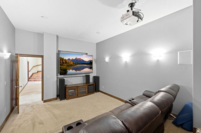 335 Bern Way Midway, UT 84049 - Photo 37 of 88 Dedicated entertainment room featuring recessed ceiling lights, wall-mounted sconces, and a ceiling-mounted projector
