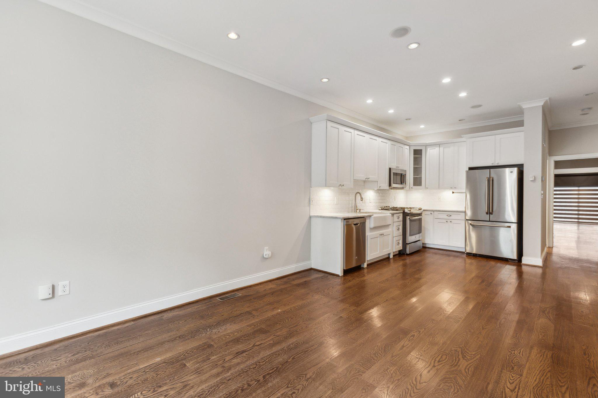 39 U Street Northeast, Unit 1 Washington, DC 20002 - Photo 3 of 22 a kitchen with stainless steel appliances a refrigerator and a sink