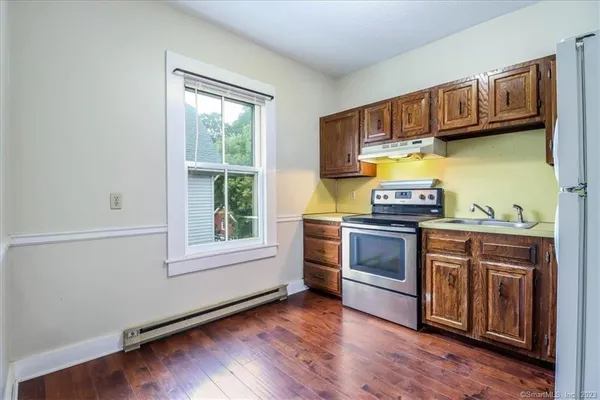 a kitchen with stainless steel appliances a stove a sink and a cabinets