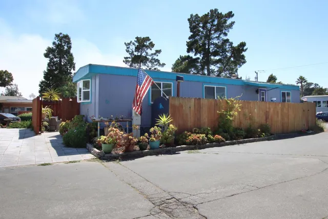 a front view of a house with a yard and a garden