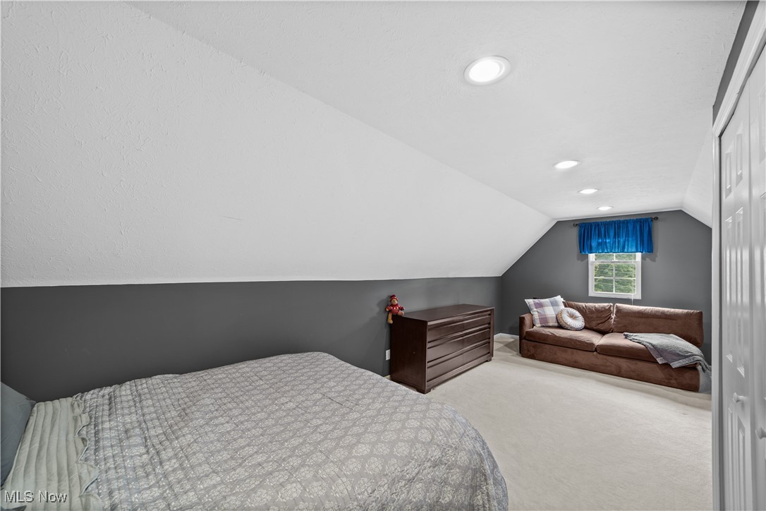 30825 Cannon Road Solon, OH 44139 - Photo 31 of 49 Bedroom featuring carpet, lofted ceiling, recessed lighting, and a closet