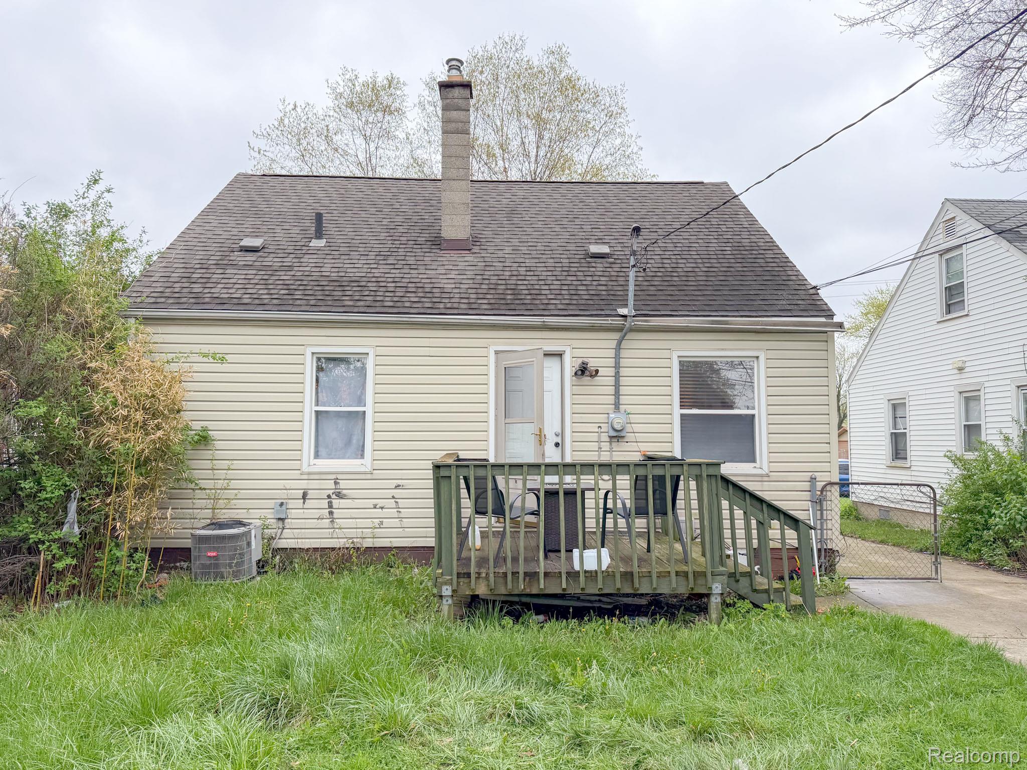 24811 Valley Avenue Eastpointe, MI 48021 - Photo 17 of 22 Back of house with a wooden deck, a chimney, a gate, and roof with shingles