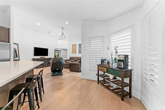 a large kitchen with stainless steel appliances granite countertop a sink and dishwasher a stove with wooden floor