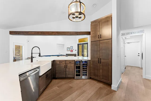 a living room with furniture a chandelier and a dining table