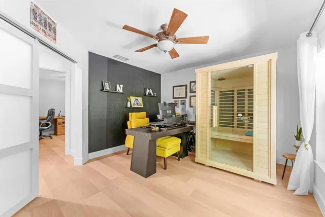 a view of a patio with a table and chairs in front of it