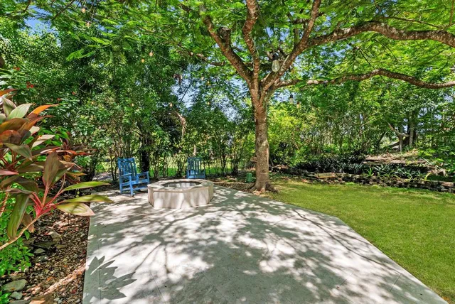 an aerial view of a house with garden space and street view