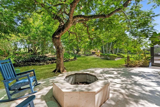 an aerial view of a house with a yard basket ball court and outdoor seating