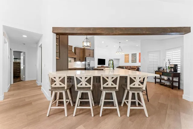a living room with furniture a pool table and a large window