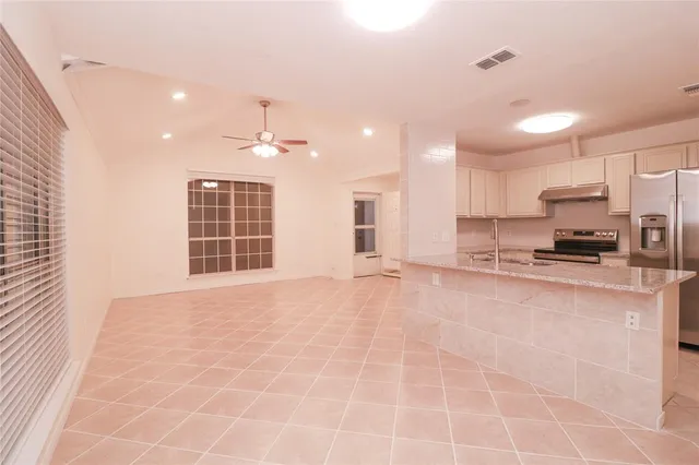 a view of a kitchen with granite countertop a large window and a sink