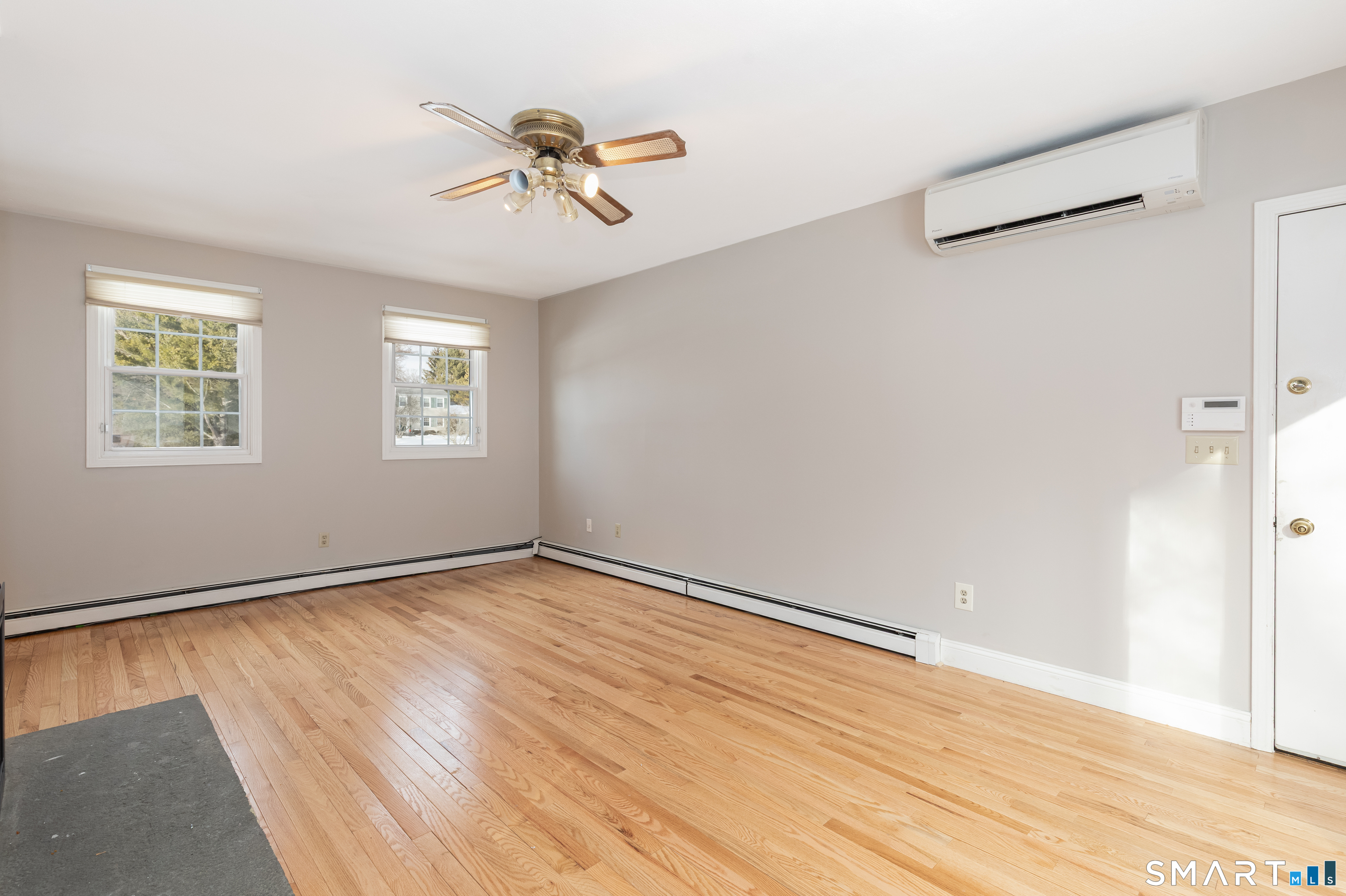 10 Apple Tree Road Bethel, CT 06801 - Photo 12 of 32 a view of an empty room with wooden floor and a window