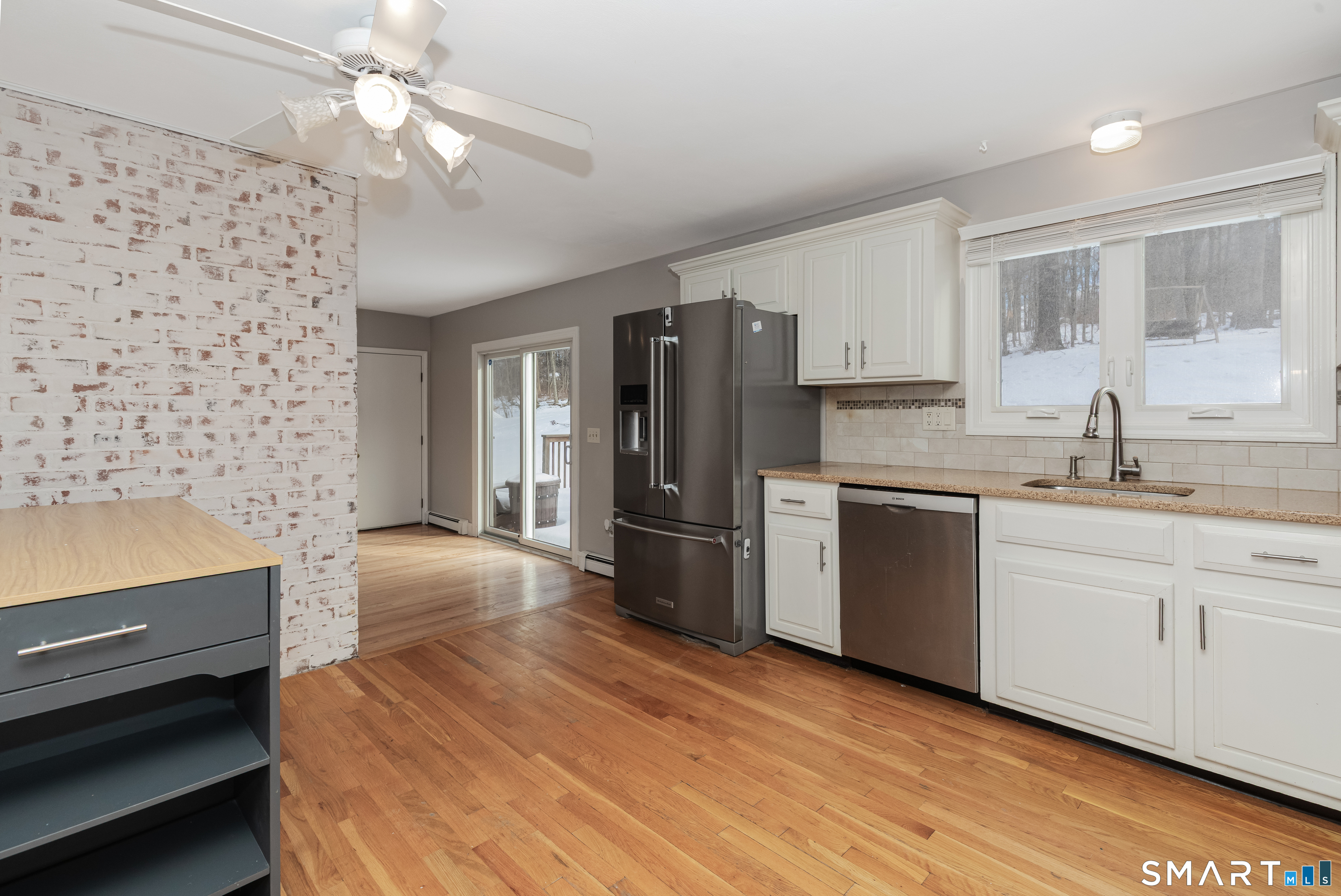 10 Apple Tree Road Bethel, CT 06801 - Photo 20 of 32 a kitchen with stainless steel appliances a refrigerator a sink and white cabinets