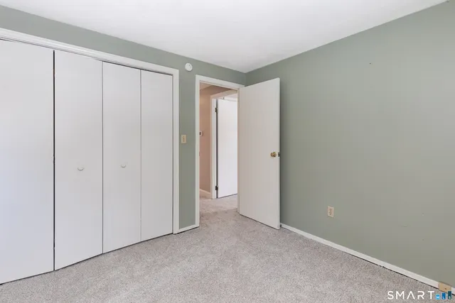 a view of an empty room and closet