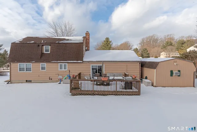 front view of house with deck and seating space