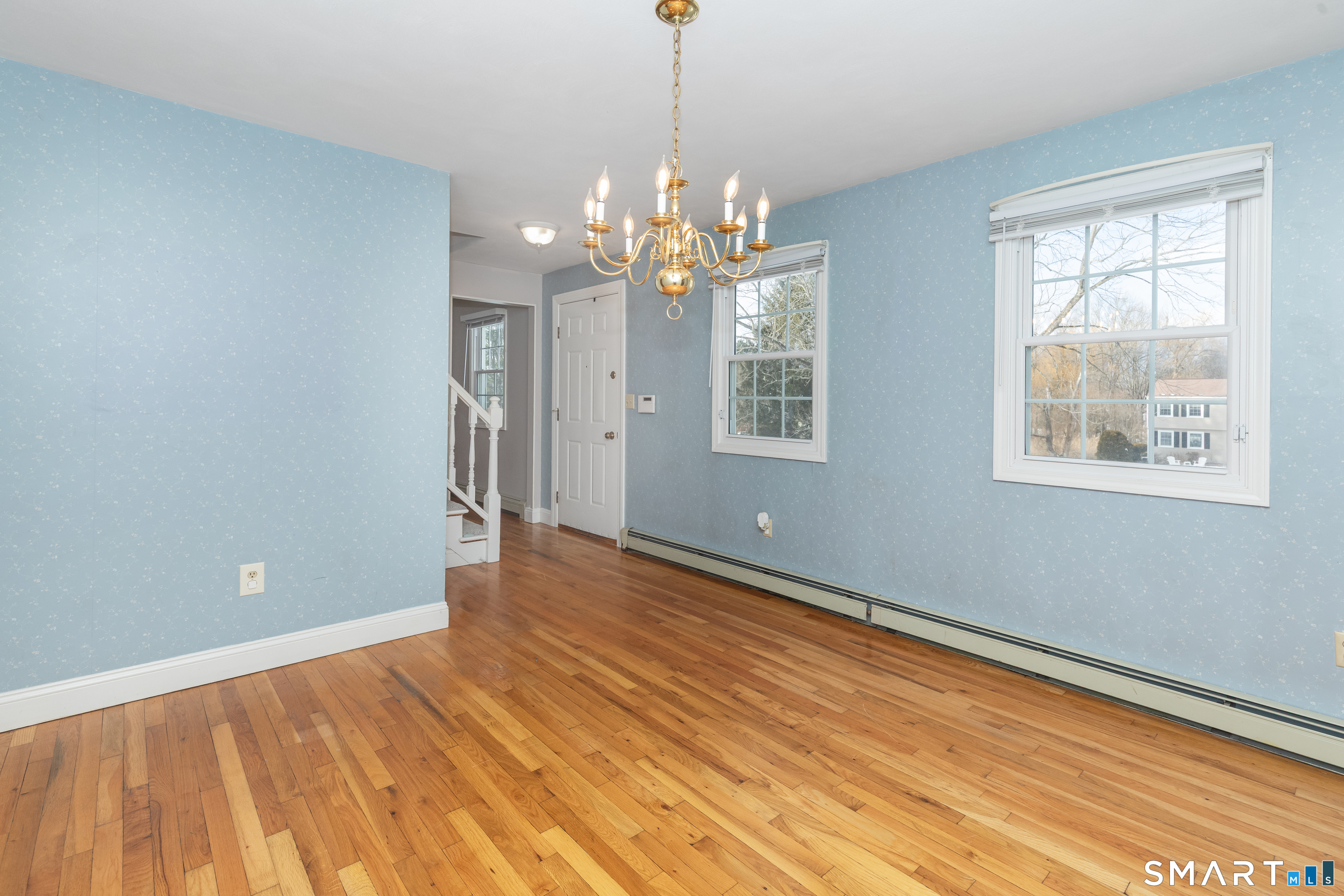 10 Apple Tree Road Bethel, CT 06801 - Photo 3 of 32 a view of an empty room with window and wooden floor