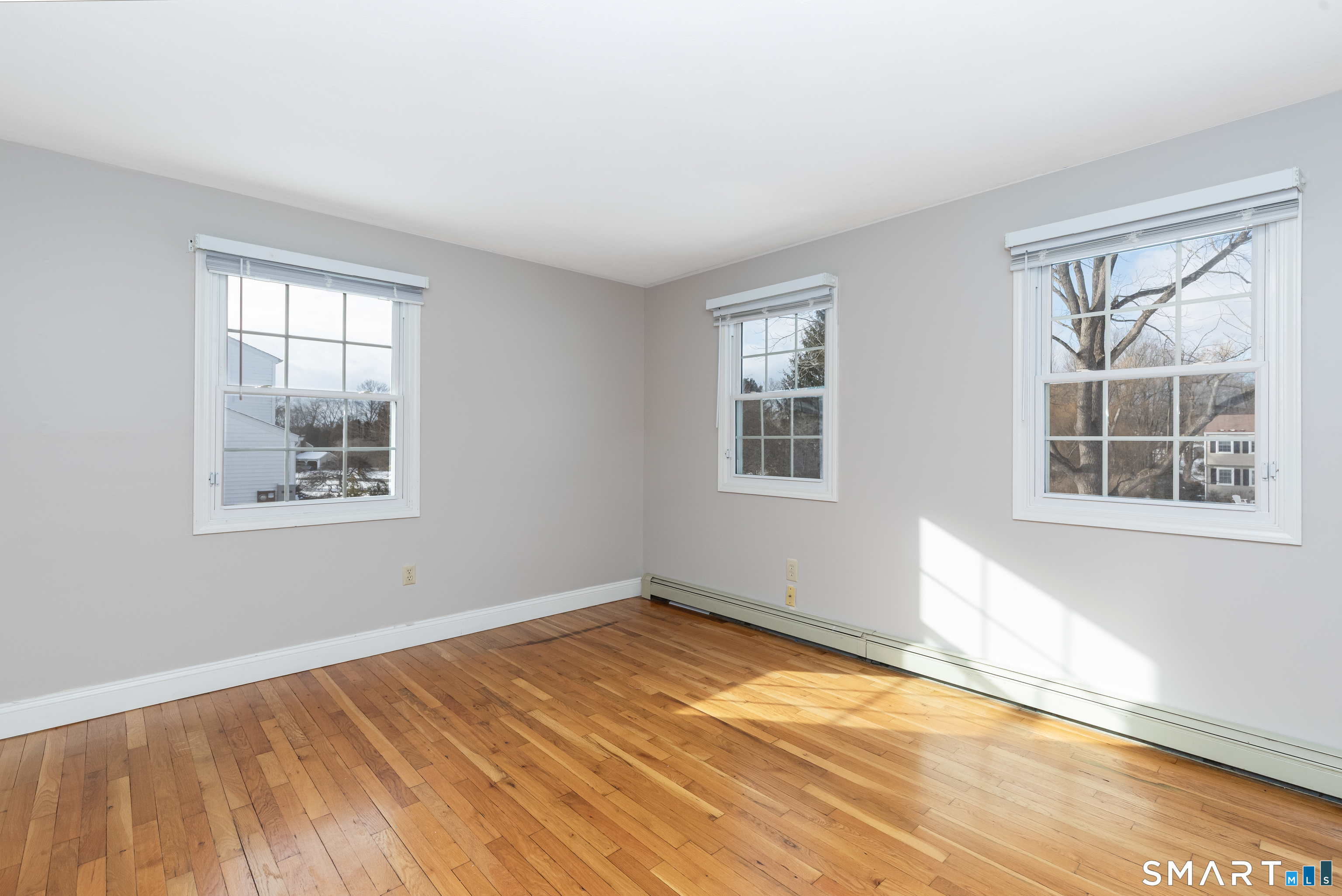 10 Apple Tree Road Bethel, CT 06801 - Photo 5 of 32 a view of empty room with wooden floor and fan