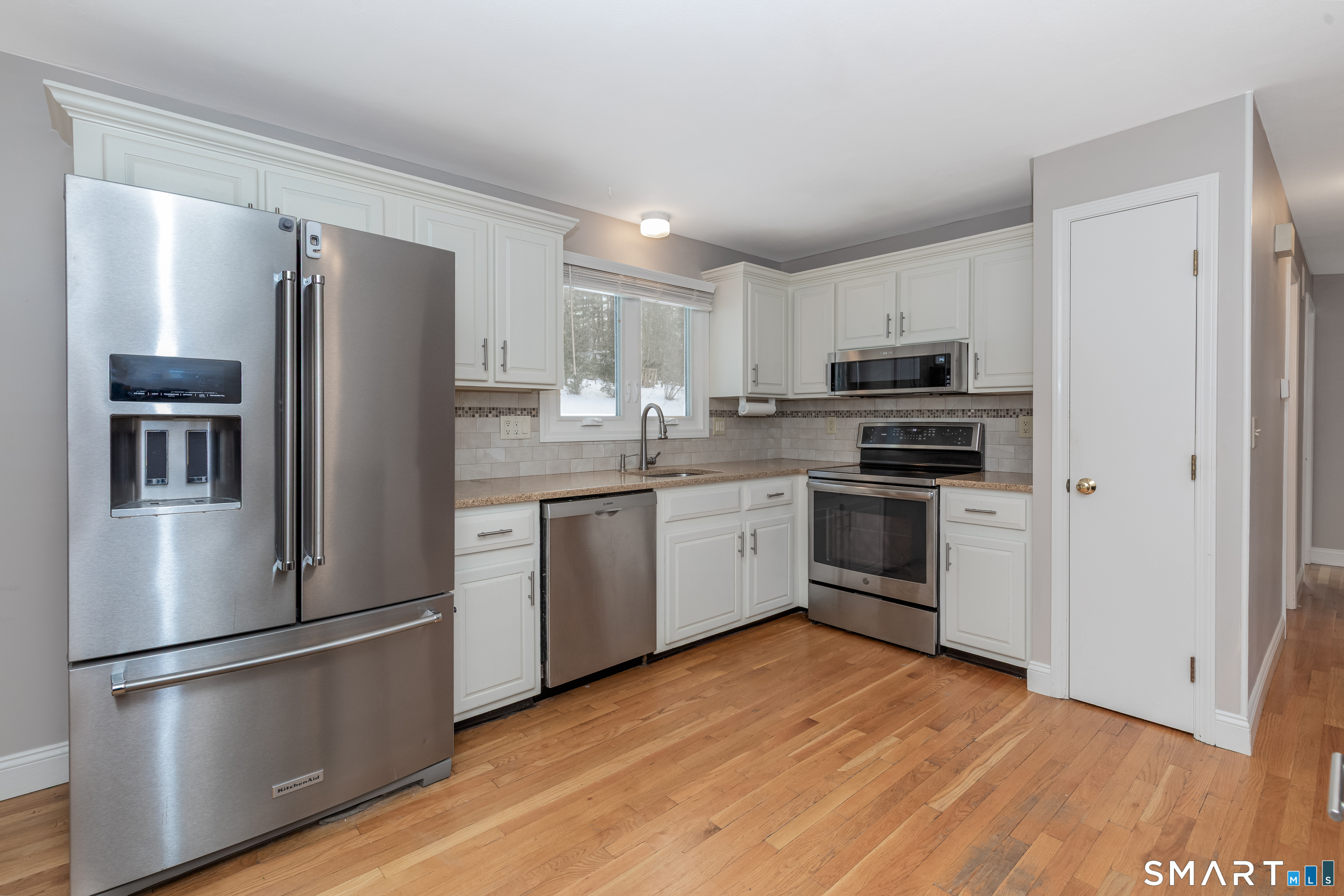 10 Apple Tree Road Bethel, CT 06801 - Photo 7 of 32 a kitchen with a refrigerator sink and wooden floor