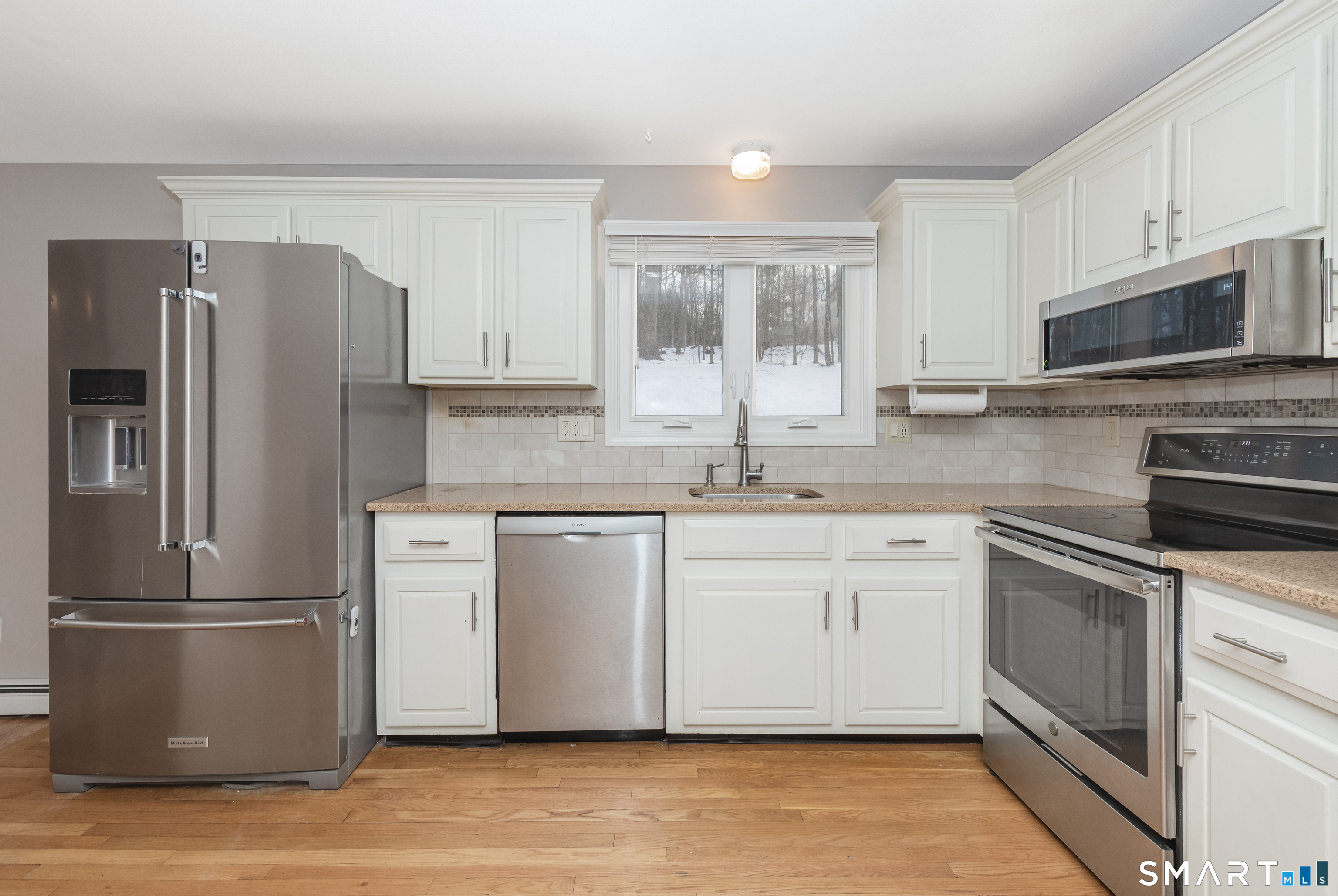 10 Apple Tree Road Bethel, CT 06801 - Photo 8 of 32 a kitchen with stainless steel appliances granite countertop a refrigerator a stove a sink and white cabinets
