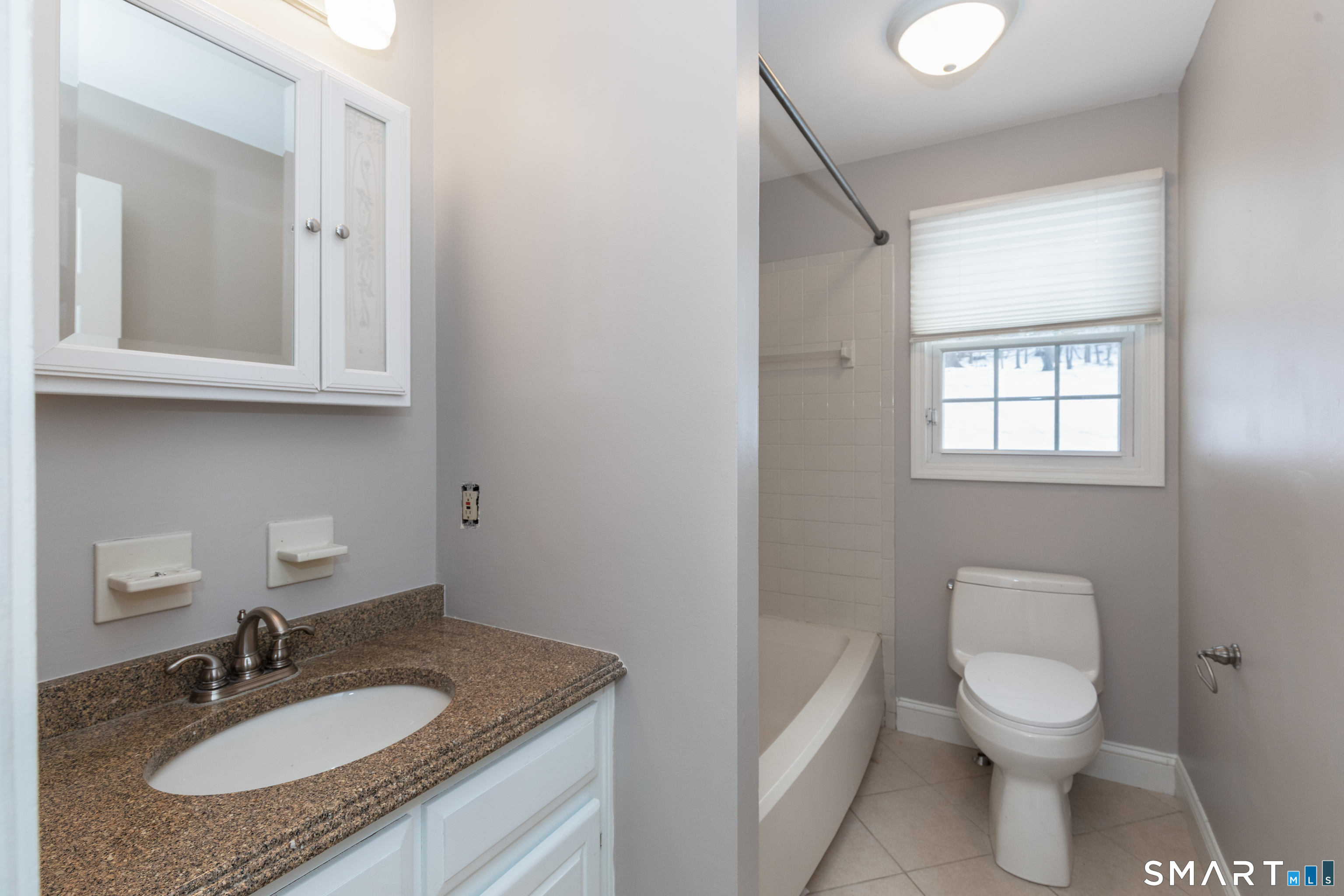 10 Apple Tree Road Bethel, CT 06801 - Photo 8 of 32 a bathroom with a granite countertop sink toilet and a mirror
