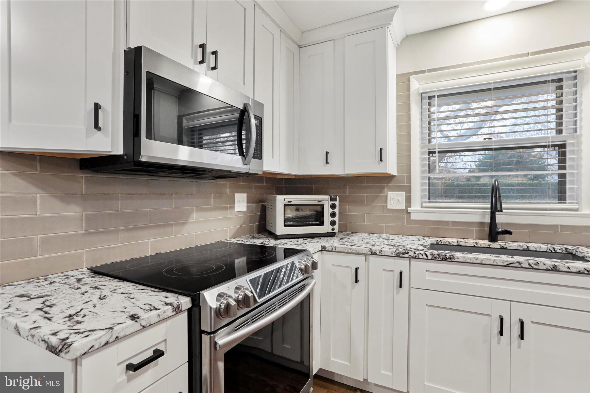 13347 Keener Road Hagerstown, MD 21742 - Photo 11 of 44 a kitchen with granite countertop a stove microwave and sink