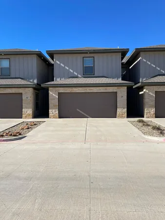 a view of a house with a wooden fence