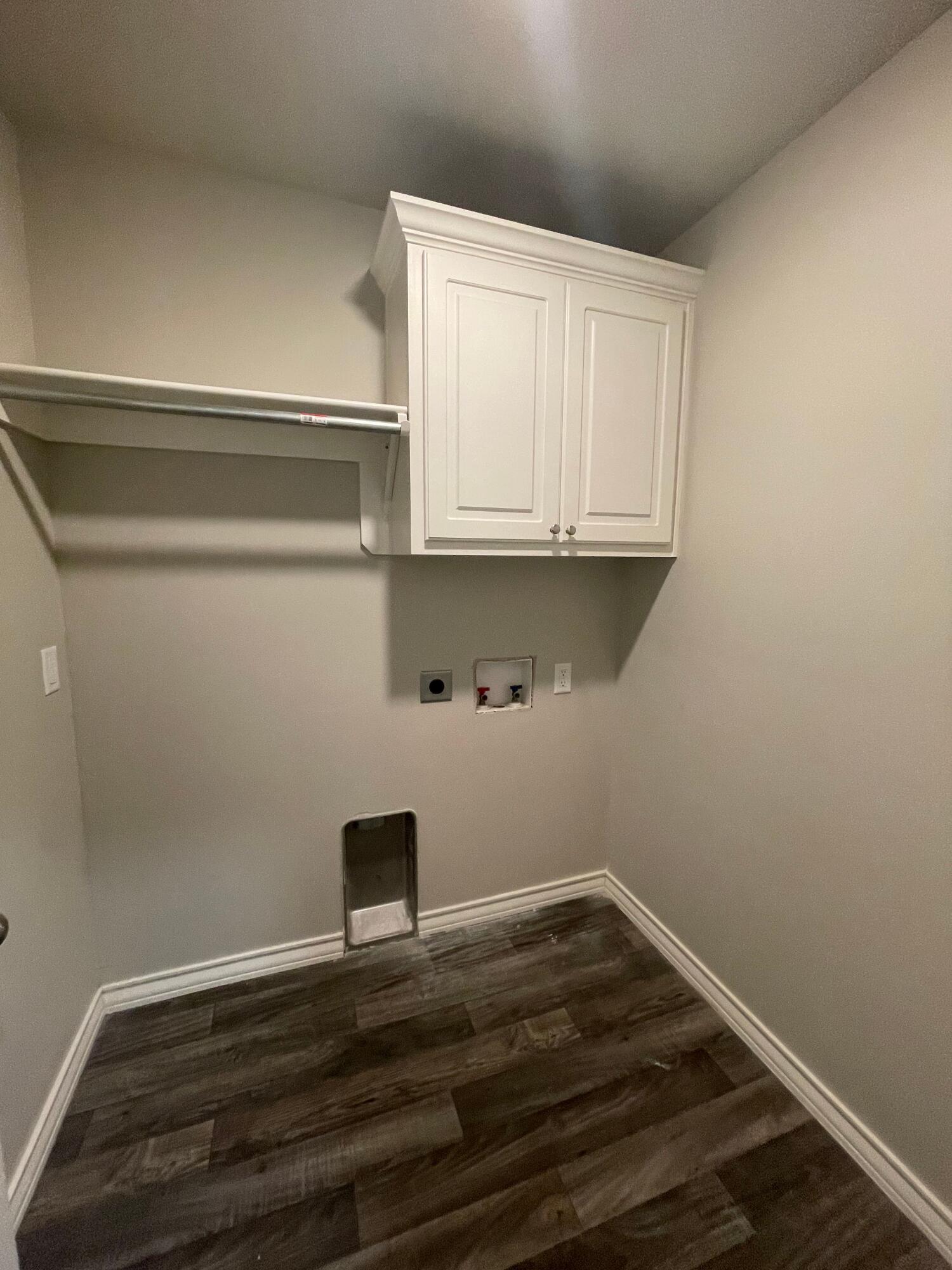 6040 24th Street, Unit 29 Lubbock, TX 79407 - Photo 12 of 15 a view of a room with wooden floor and cabinets
