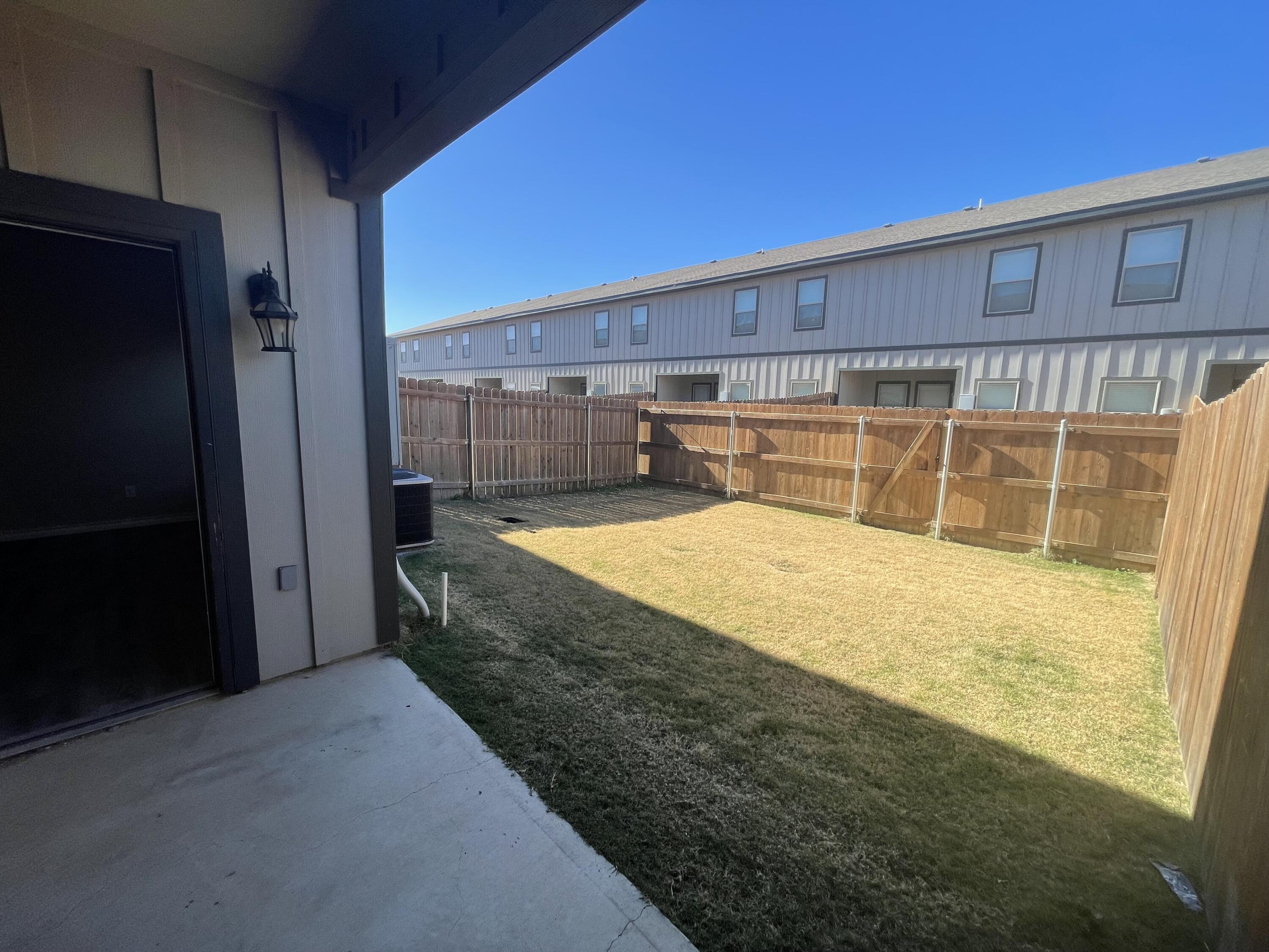 6040 24th Street, Unit 29 Lubbock, TX 79407 - Photo 13 of 15 a view of a backyard