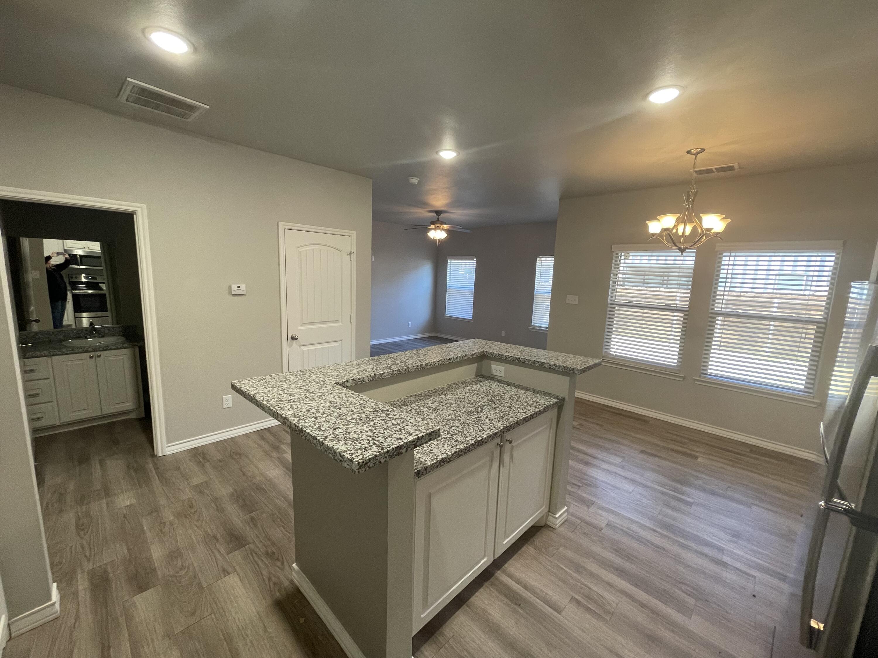 6040 24th Street, Unit 29 Lubbock, TX 79407 - Photo 3 of 15 a kitchen with stainless steel appliances granite countertop a sink stove and cabinets