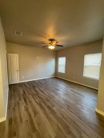 a view of an empty room and wooden floor