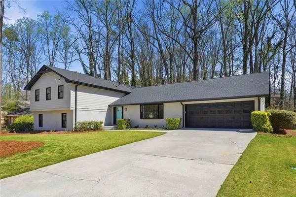 a front view of house with yard and green space