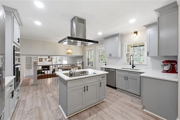 a kitchen with a sink stove and cabinets