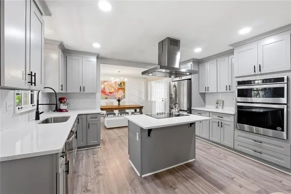 a kitchen with counter top space a sink appliances and cabinets