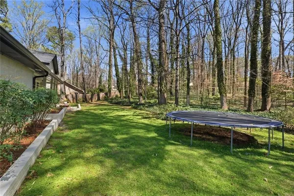 a backyard of a house with table and chairs