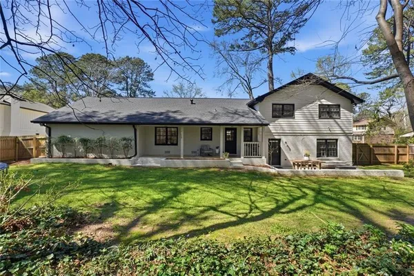 a front view of a house with a garden and porch