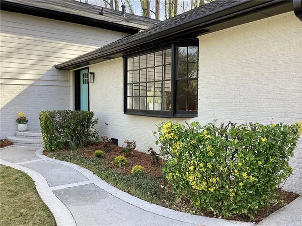 a front view of a house with garden