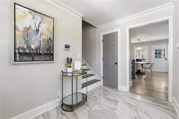 a view of a livingroom with wooden floor and furniture