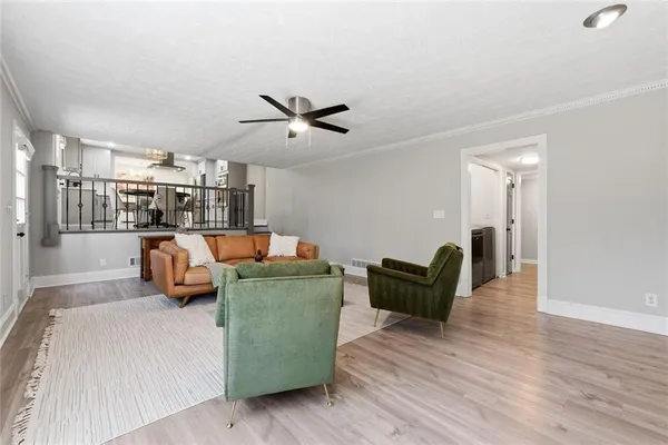 a living room with furniture and a wooden floor