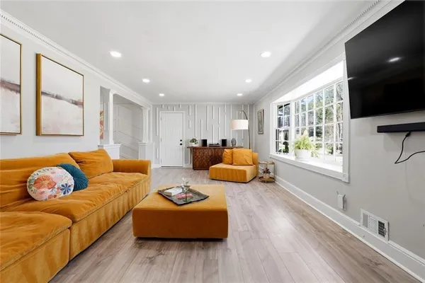 a living room with furniture window and flat screen tv
