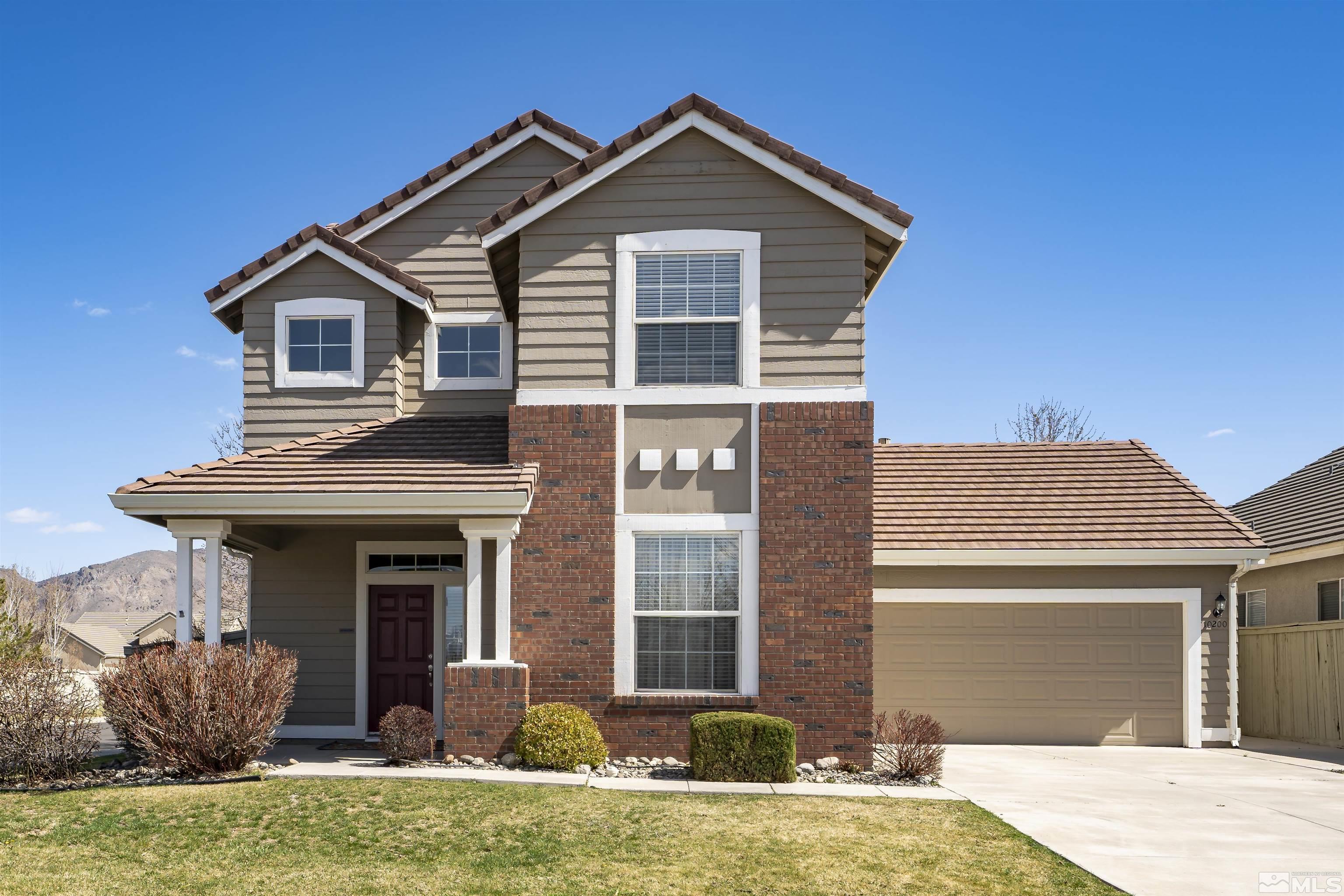 10200 Wolf Ridge Way Reno, NV 89521 - Photo 1 of 40 a front view of a house with garden