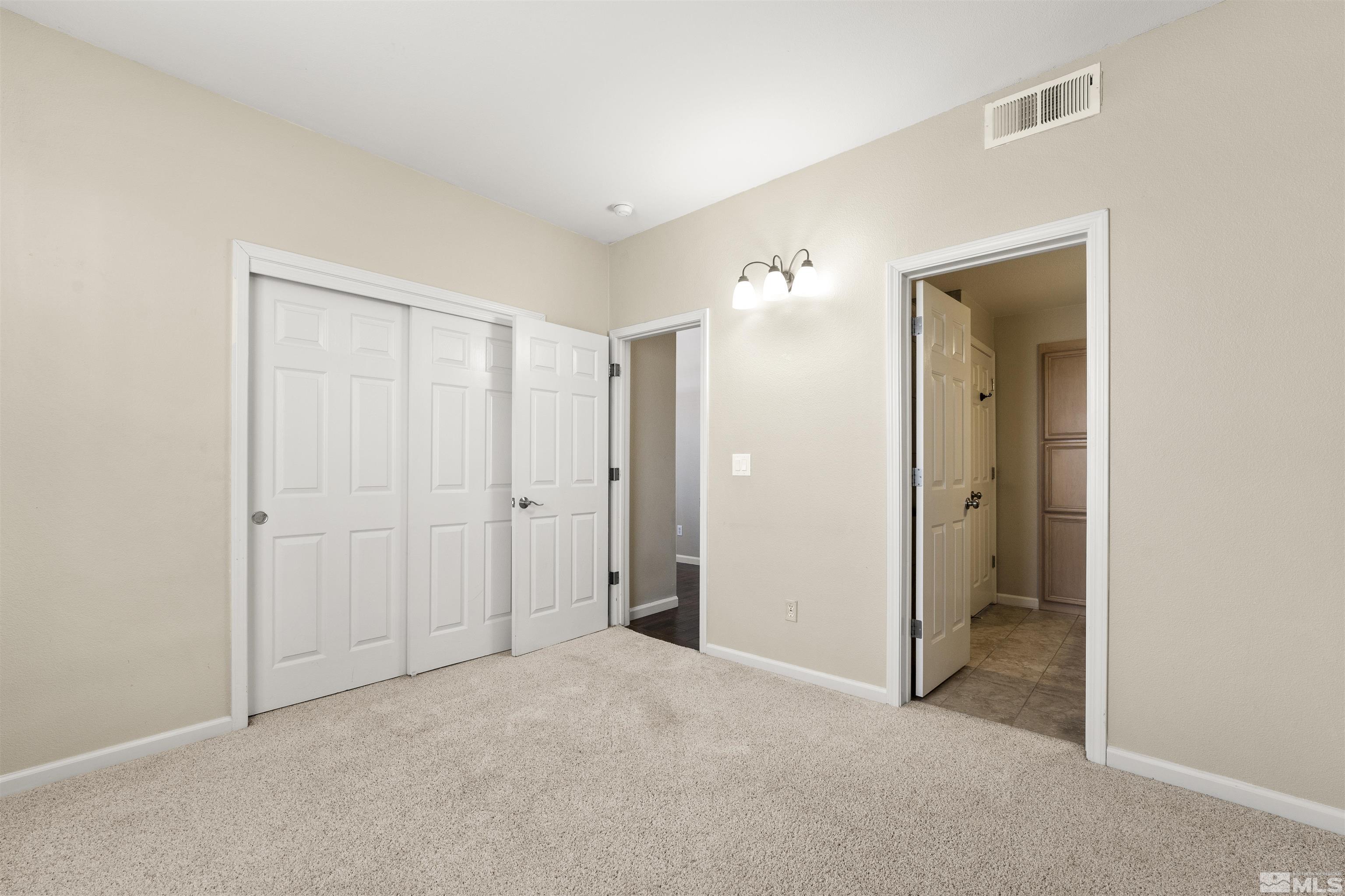 10200 Wolf Ridge Way Reno, NV 89521 - Photo 19 of 40 a view of an empty room with closet and a window