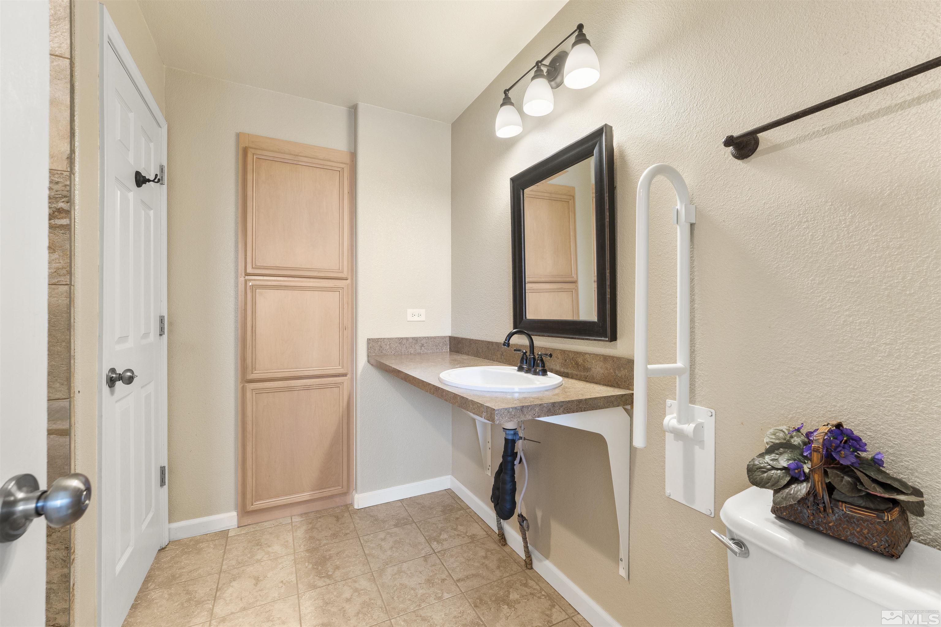 10200 Wolf Ridge Way Reno, NV 89521 - Photo 20 of 40 a bathroom with a sink and a mirror