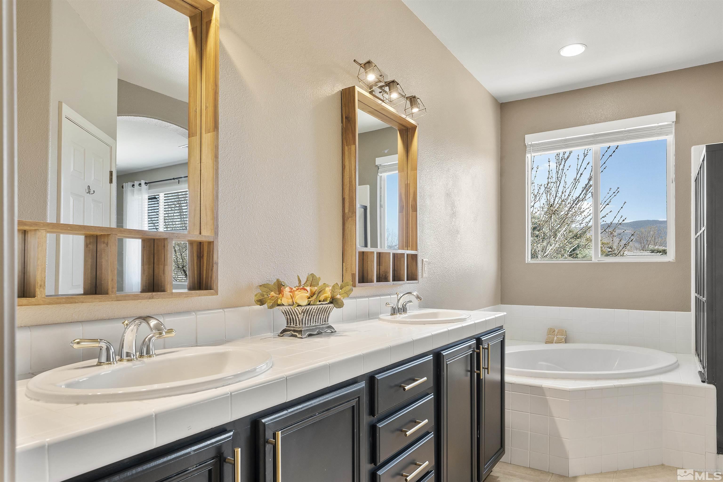 10200 Wolf Ridge Way Reno, NV 89521 - Photo 22 of 40 a bathroom with a double vanity sink and a bathtub