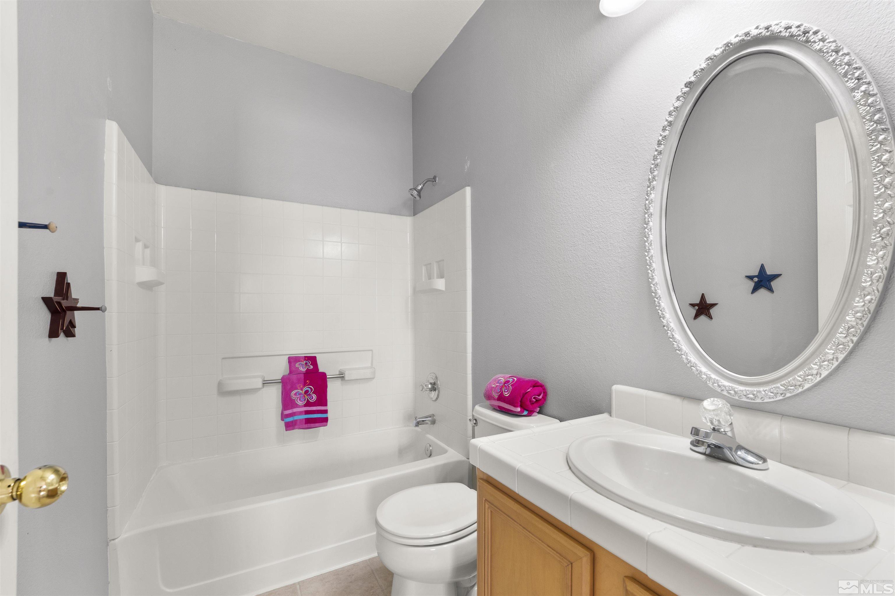 10200 Wolf Ridge Way Reno, NV 89521 - Photo 25 of 40 a bathroom with a sink and a mirror