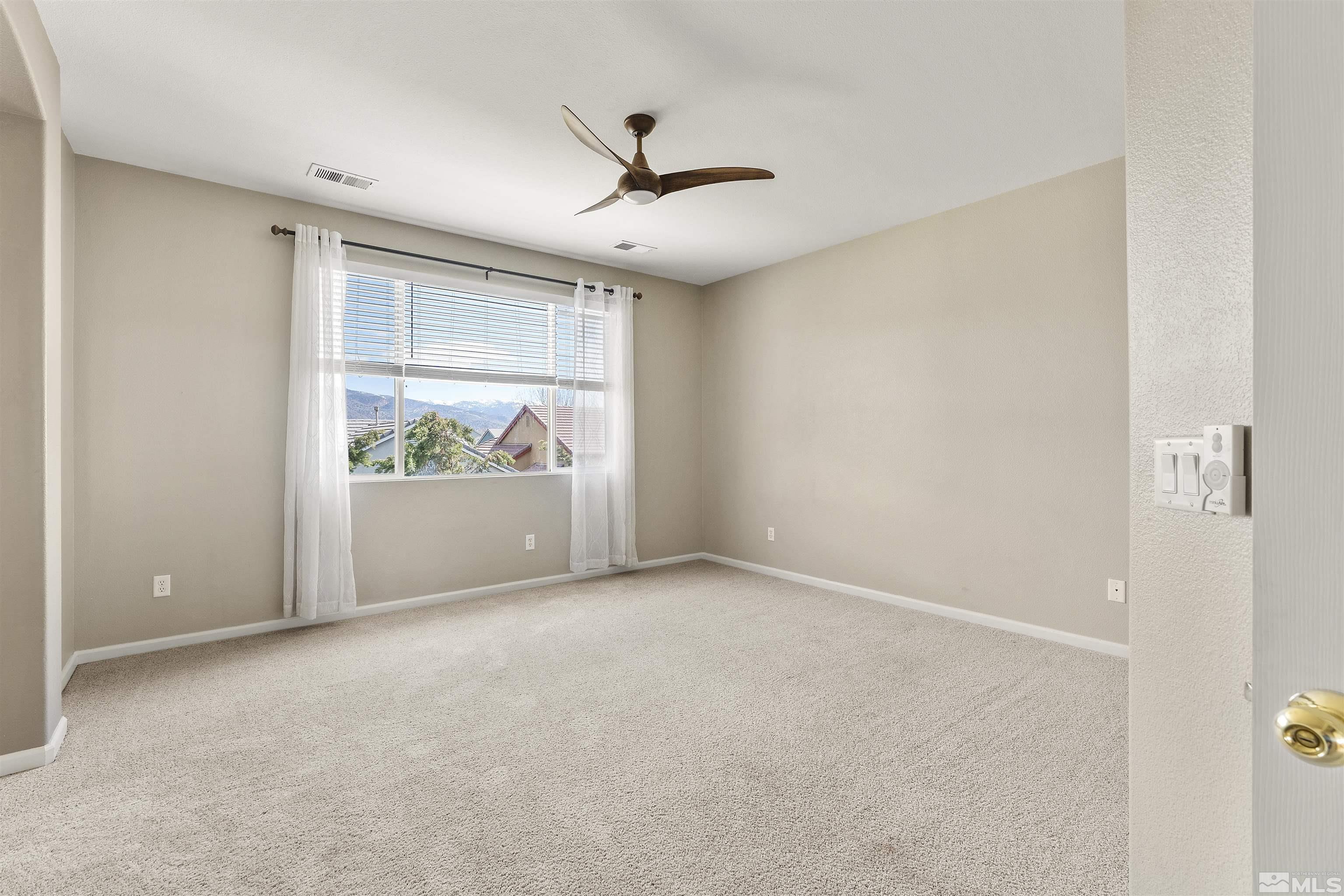 10200 Wolf Ridge Way Reno, NV 89521 - Photo 27 of 40 a view of an empty room with a window