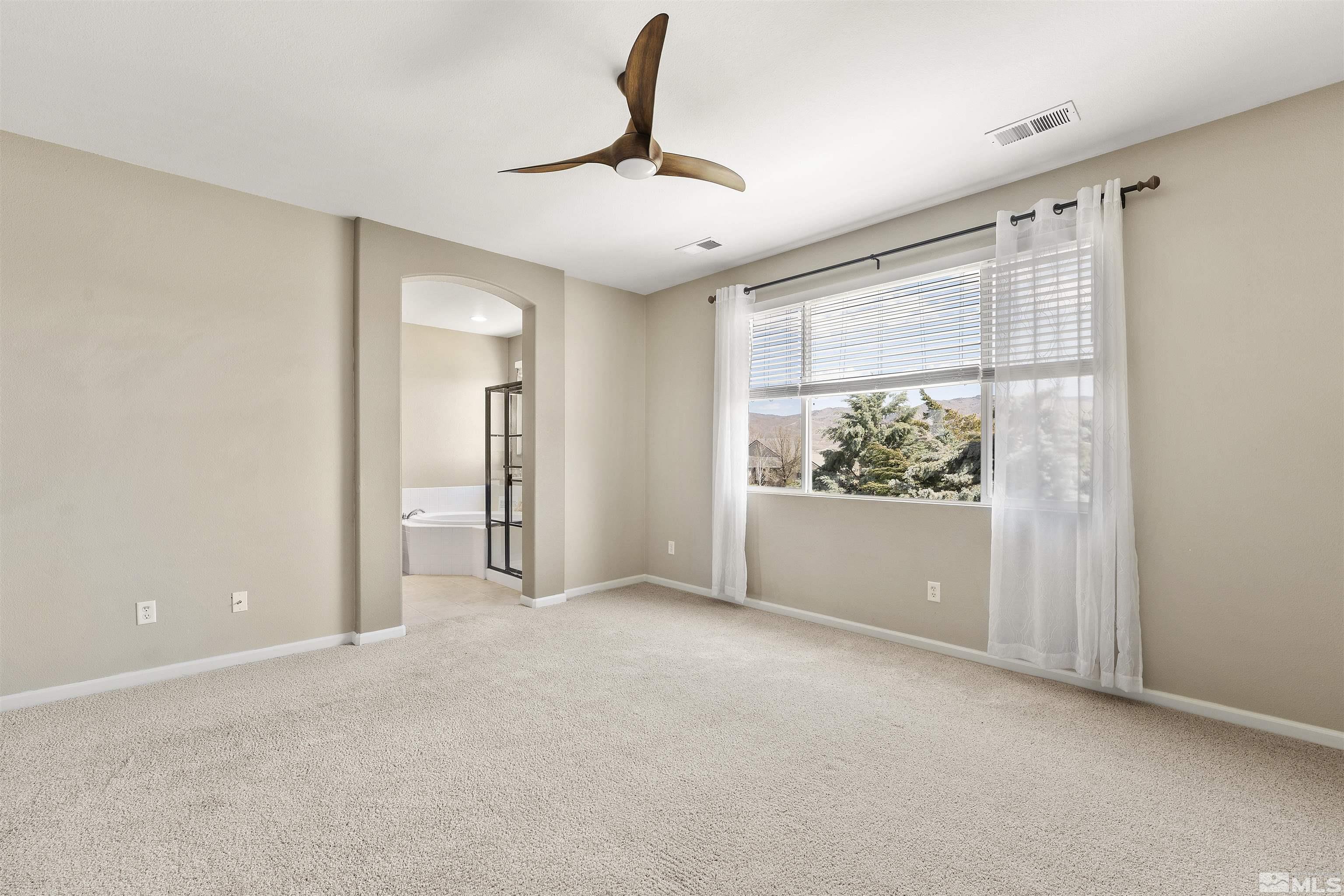 10200 Wolf Ridge Way Reno, NV 89521 - Photo 28 of 40 a view of an empty room with a window